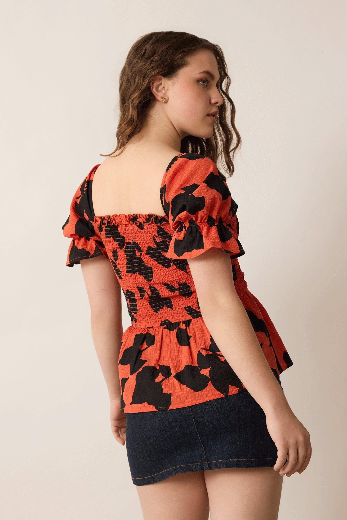 Bailey in Bold Peplum Top In Orange and Black